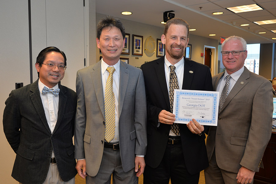 Georgia DOT Research Implementation Manager Binh Bui, Georgai Tech Professor James Tsai, and Assistant State Research Engineer David Jared receive their American Association of State Highway and Transportation Officials 2017 Sweet Sixteen Award from DOT Commissioner Russell McMurry at the October meeting of Georgia’s State Transportation Board. (Photo Courtesy: Georgia Department of Transportation)