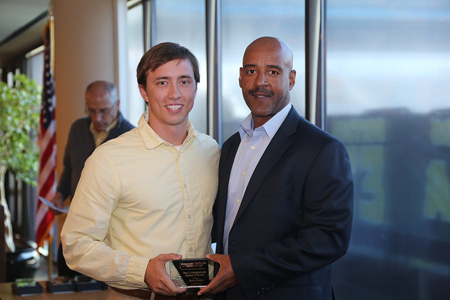 Brian Emrich receives his award from School Chair Reginald DesRoches. (Photo: Jess Hunt-Ralston)