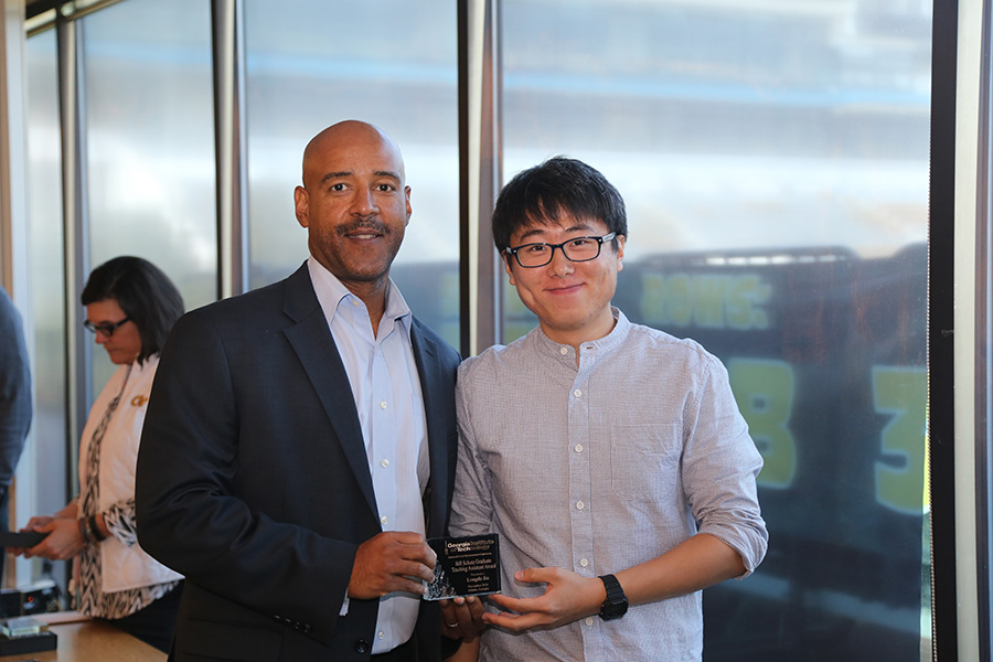 Longde Jin receives his award from School Chair Reginald DesRoches. (Photo: Jess Hunt-Ralston)