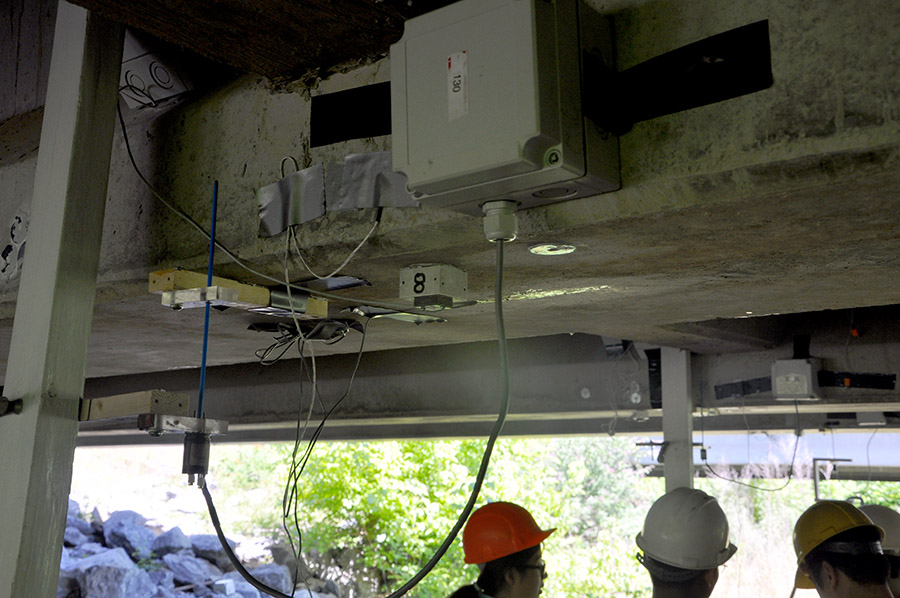 Yang Wang and students in his research group install sensors on a bridge in Bartow County, Georgia, in July 2016. Wang, Francesco Fedele and Rafi Muhanna in the School of Civil and Environmental Engineering will use data from instruments like these to feed a new interval-based optimization approach to assess structural systems and detect damage. (Photo Courtesy: Yang Wang)