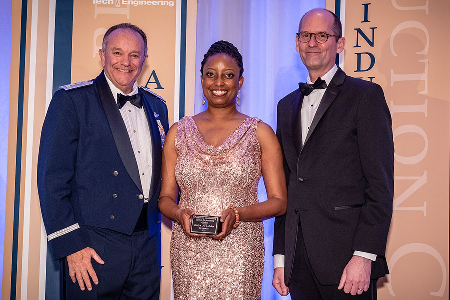 Alumna Zakiya Seymour, center, was inducted into the Georgia Tech College of Engineering Council of Outstanding Young Engineering Alumni April 21. She's holding her award alongside the ceremony's guest speaker, retired Gen. Philip Breedlove, left, and engineering Dean Steve McLaughlin. (Photo: Gary Meek)