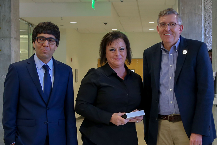 Melisa Hubbs, center, receives her award from awards committee chair Arash Yavari, left, and School Chair Donald Webster.  (Photo: Amelia Neumeister)