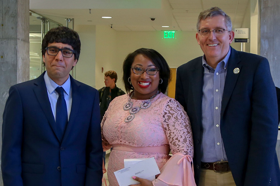 Jamia Luckett, center, receives her award from awards committee chair Arash Yavari, left, and School Chair Donald Webster.  (Photo: Amelia Neumeister)