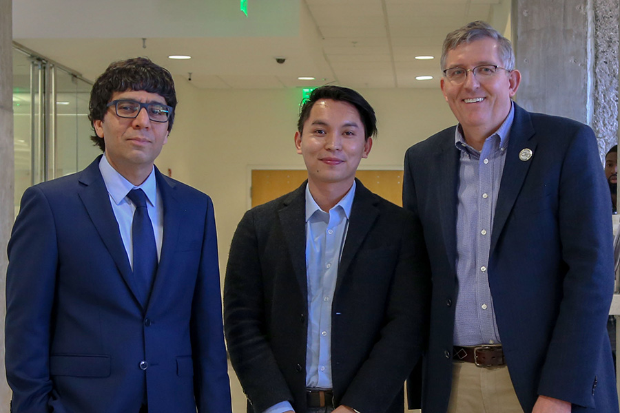 Cong Luo, center, receives his award from awards committee chair Arash Yavari, left, and School Chair Donald Webster.  (Photo: Amelia Neumeister)