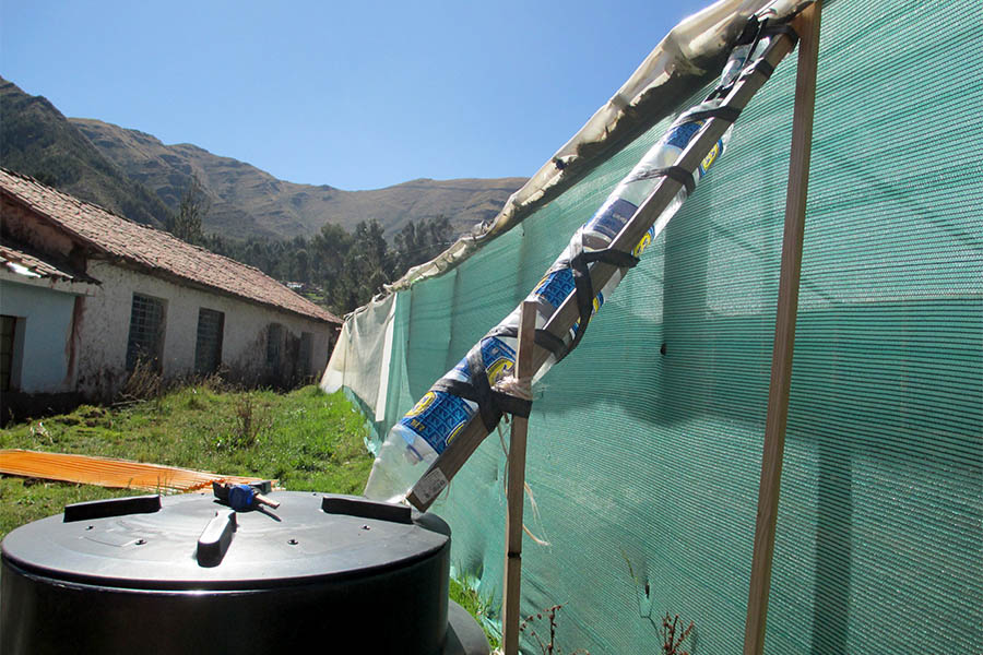 A rainwater cistern with a gutter made of recycled Inca Kola bottles, a popular soda in Peru. Undergraduate Maya Goldman fixed this gutter system as part of day volunteering at an elementary school outside of Cuzco, Peru, during her summer 2016 study abroad trip to the South American country. "The main idea of this project was to show the kids a creative way of recycling plastic bottles while collecting precious water resources," Goldman said. (Photo: Maya Goldman)