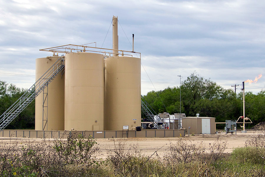 Natual gas storage tanks with excess methane burning off. (Photo Courtesy: Jeffrey Phillips via Flickr)