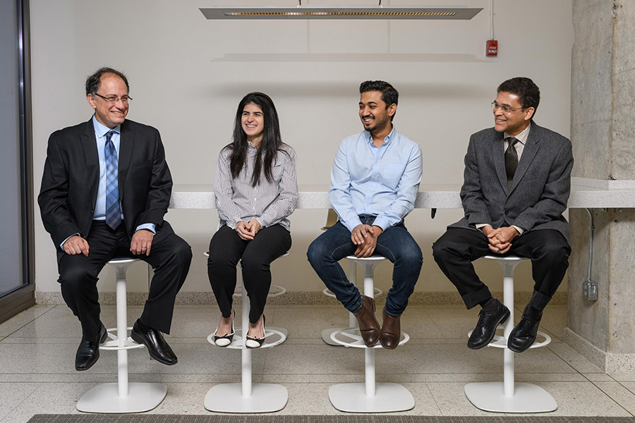 Researchers have created a configurable radio-frequency filter using origami and ink made of silver that’s printed across the folds. By changing the configuration of the filter, the silver dipoles block different frequencies. The research team included, from left to right, Manos Tentzeris, the Ken Byers Professor in Flexible Electronics in the School of Electrical and Computer Engineering; graduate students Larissa Novelino and Abdullah Nauroze; and Glaucio Paulino, the Raymond Allen Jones Chair in the School of Civil and Environmental Engineering (Photo: Rob Felt)