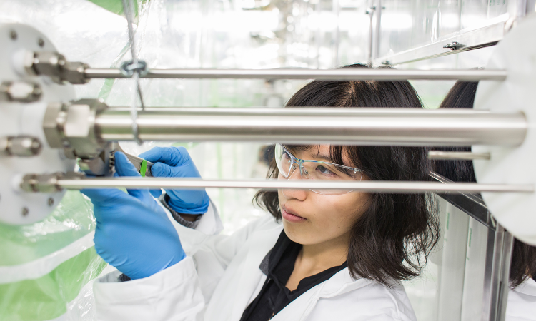 Woman adjusting experiment device