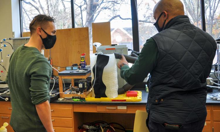 Two men looking at lab equipment 