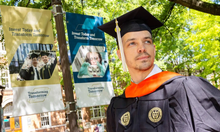 Thomas Vandiver in a cap and gown for graduation 