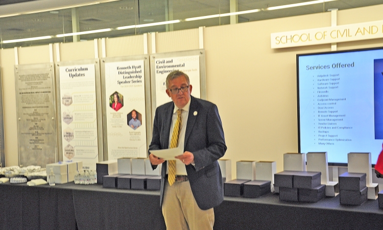 Karen and John Huff Chair Don Webster addressing the gathering in the Mason building lobby.