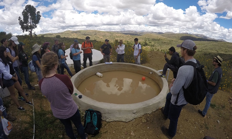 Students learn about a rainwater collector in the El Campo community from a local engineering during their Spring Break research trip to Bolivia. The trip, part of the Environmental Technology in the Developing World class, included days of collecting water samples and surveying residents as well as days learning how rural communities have developed their own water systems. (Photo: Donald Smith)