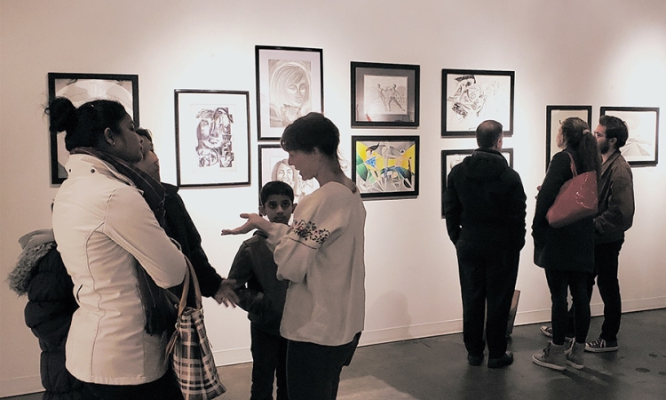 Visitors consider the artwork created by students in Francesco Fedele's Visual Arts and Geometry course at the Kai Lin Gallery Dec. 11. The drawings hung for one night at the gallery to celebrate the students' work in the class, which connected advanced geometry with art through the lenses of Einstein and Picasso.