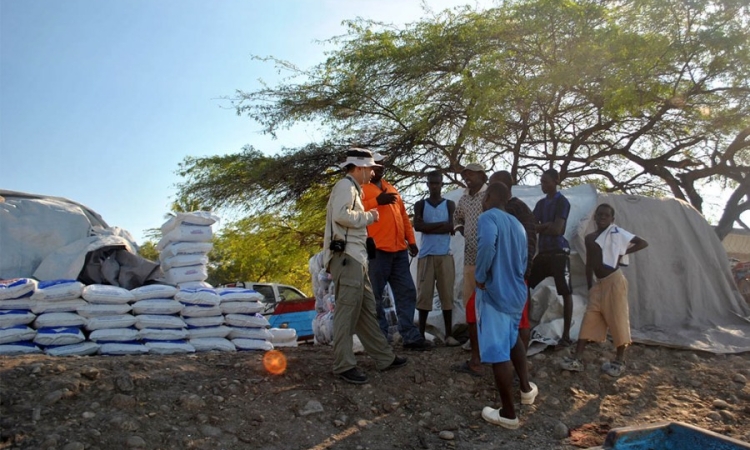 Hermann Fritz, right, talks with people in Haiti on one of his research trips after an earthquake wreaked havoc on the island nation in 2010. Fritz told public radio's Marketplace the temporary communities that have since sprung up on the country's hillsides are now at risk from flooding and landslides in the wake of Hurricane Matthew. (Photo: Jean Vilmond Hilaire, Université de Quisqueya)