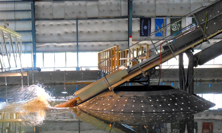 A simulated landslide splashes into a wave basin at Oregon State University.