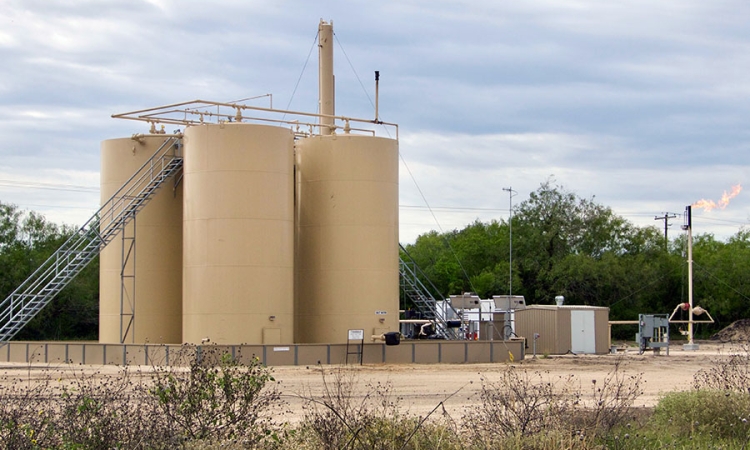 Natual gas storage tanks with excess methane burning off. (Photo Courtesy: Jeffrey Phillips via Flickr)