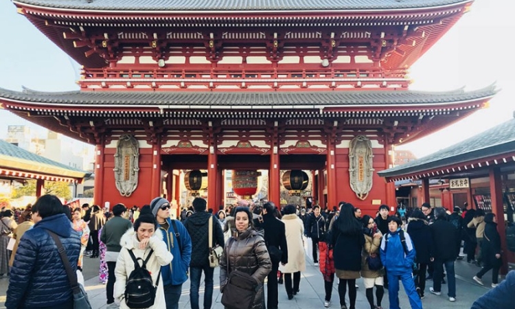 Fizza Hassan, center, stands in front of the Sensoji Buddhist Temple in Tokyo's Asakusa neighborhood. Hassan, a civil engineering master's student, traveled to the city with her classmates from an origami engineering course she took at Georgia Tech in the fall taught by Glaucio Paulino. The class visited attractions around Japan and learned about origami principles from Paulino's collaborators in the country. (Photo Courtesy: Fizza Hassan)