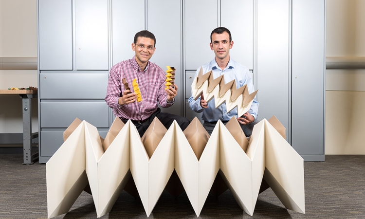 Glaucio Paulino and Evgueni Filipov with models of their zippered tube origami configuration. (Photo: Rob Felt)