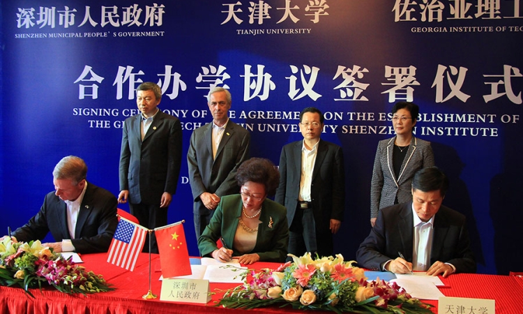 Georgia Tech President G.P. “Bud” Peterson, seated left, signed an agreement in a ceremony in Shenzhen, China, Dec. 2 to create a new collaboration with the City of Shenzhen and Tianjin University. Co-signers with Peterson are Vice Mayor Yihuan Wu of Shenzhen Municipal People's Government, center, and Tianjin University President Denghua Zhong, right.