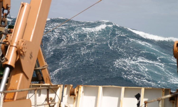 A large wave towers astern of the NOAA ship Delaware II in the Atlantic Ocean in 2005. (Photo: Delaware II Crew/NOAA)