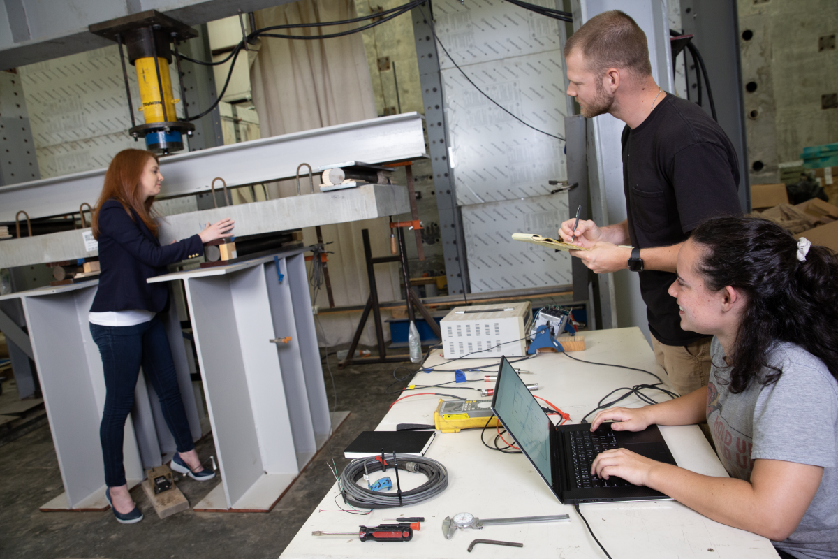 three people working in the structures lab