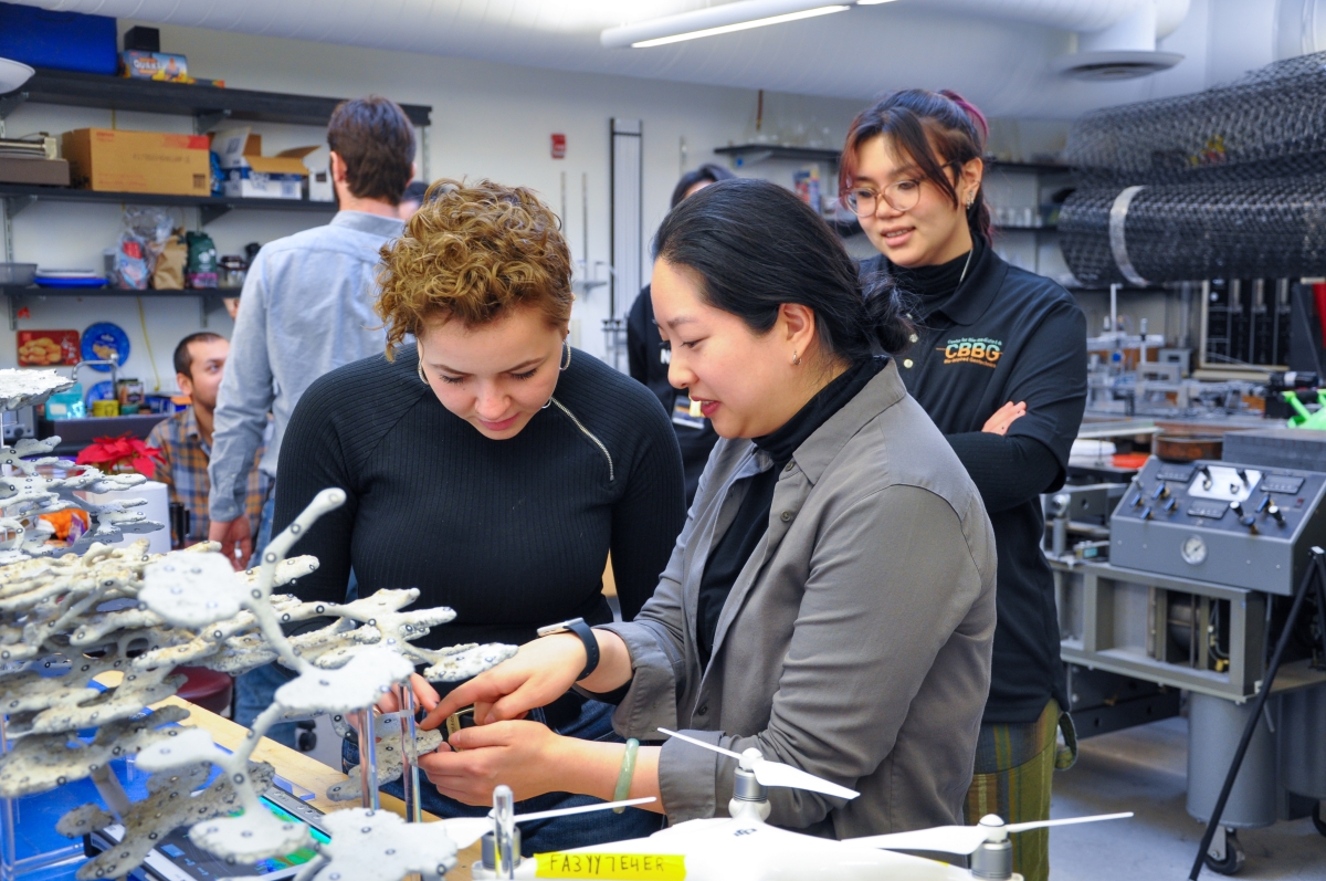 students looking at a model in a laboratory