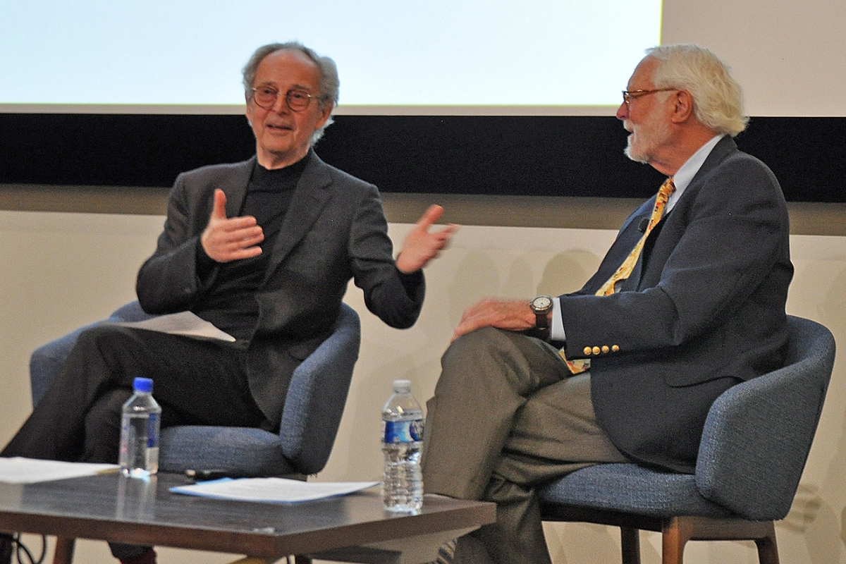 Two men seated in conversation 