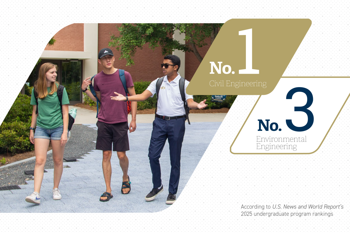 Group of three students walking in the Mason building plaza