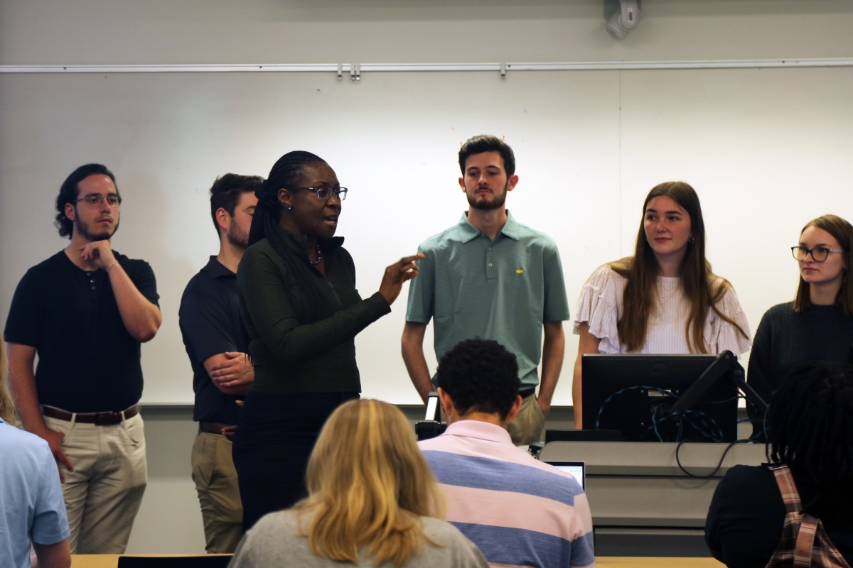 A professor in front of a group of students 