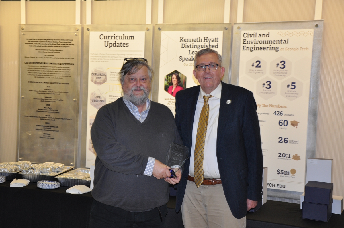 Portrait of Professor David Frost holding award with Chair Don Webster