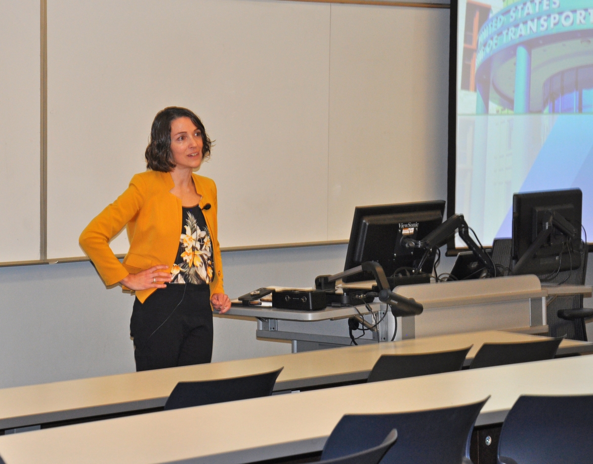 Woman in Yellow Jacket answering question