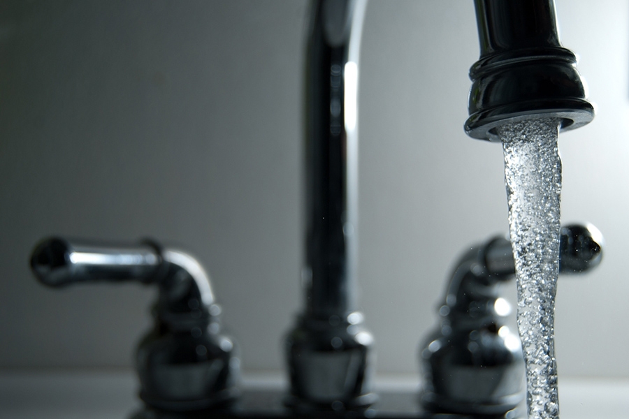 Water pouring from a faucet. (Photo Courtesy: Steve Johnson via Flickr)