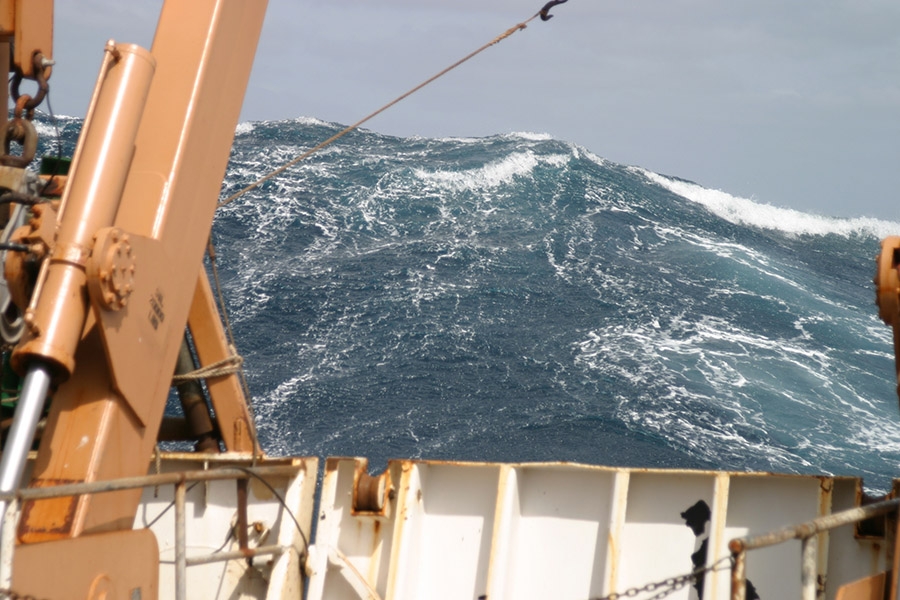 A large wave towers astern of the NOAA ship Delaware II in the Atlantic Ocean in 2005. (Photo: Delaware II Crew/NOAA)