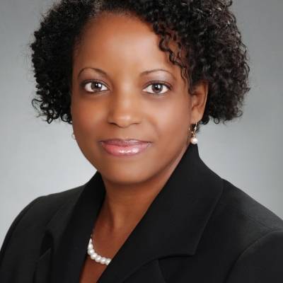Portrait of Daveitta Knight in a black blazer and pink blouse