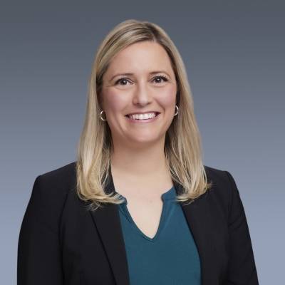 Portrait of Kate Henry in a blue blouse and black blazer