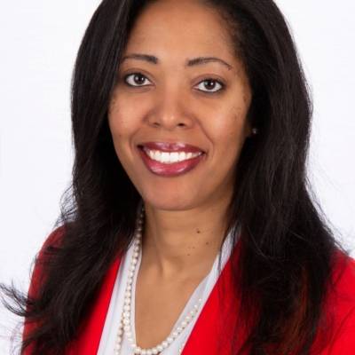 Portrait of Stacy Blakley in a white shirt with a red blazer